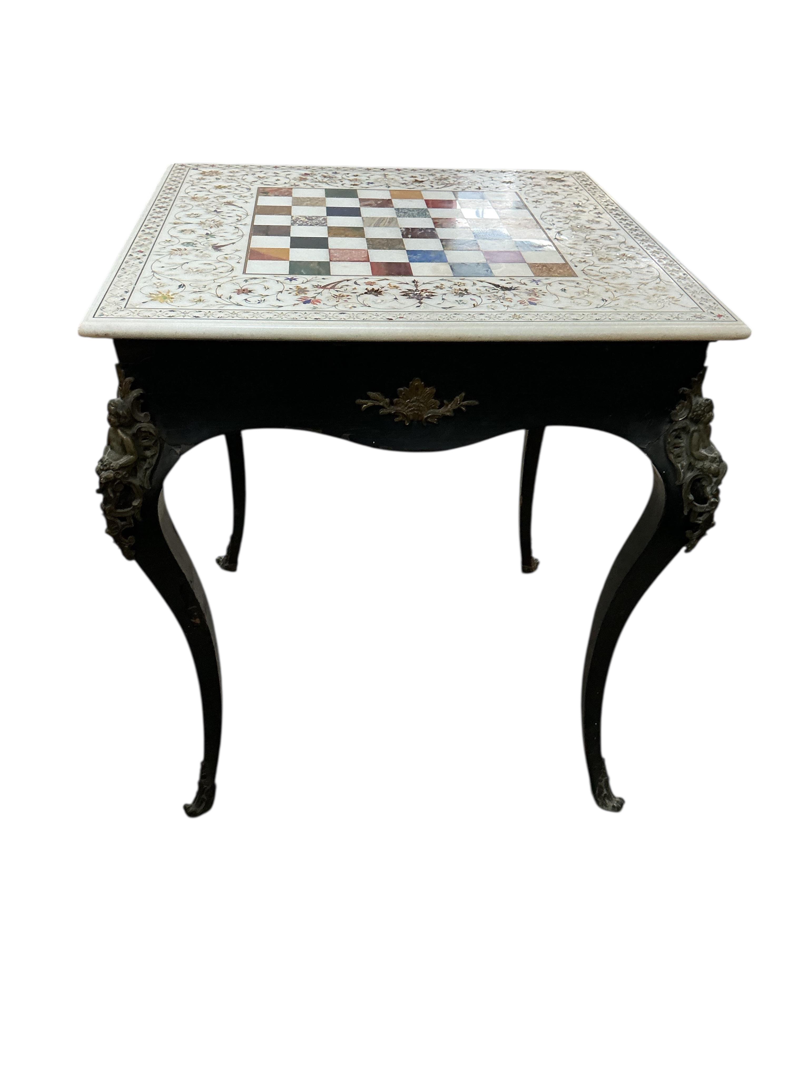 An Indian specimen marble chess set on an earlier associated gilt metal ebonised stand, width 68cm, height 74cm